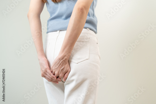 Health care, pain asian young woman suffering from hemorrhoid, anus, diarrhea and constipation, girl hand touching, holds butt, anal have abdominal, intestine problem, abscess disease and smell fart.