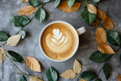 Nature themed coffee cup with leaf arrangement in a flat lay position