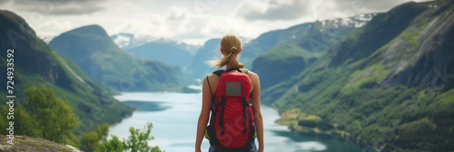 Young female hiker with a backpack admiring scenic view of spectacular Icelandic nature on a sunset. Breathtaking landscape of Iceland. Hiking by foot.