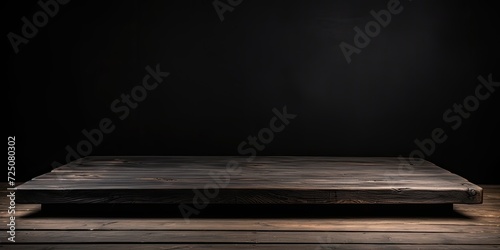 Black wood table for placing objects on a black background with a 45-degree side view.