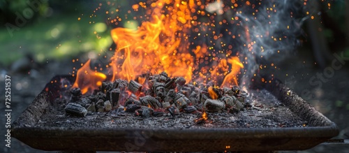 Nature's gas burner sparks and ignites an old rusty iron barbecue, causing coals to flare up on a day off.