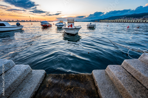 Dusk and night in Trieste. Between historic buildings and the sea.