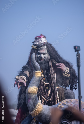 Masan Holi, Portrait of an male artist act as lord shiv with dry ash on face and body also in air while celebrating the masan holi as tradition at Harishchandra ghat.