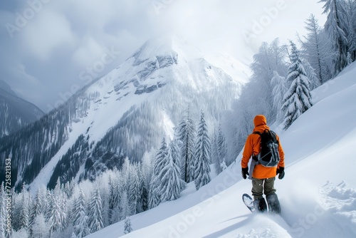 Man practices freeriding on a snowboard in the mountains