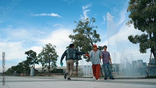 Attractive asian break dancer giving high five with group of hipster.. Professional happy funny man wear stylish hip hop cloth and prepare to perform freestyle dancing. Outdoor sport 2024. Sprightly.