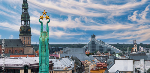 Beautiful sunrise view over Riga by the statue of liberty - Milda in Latvia. The monument of freedom.