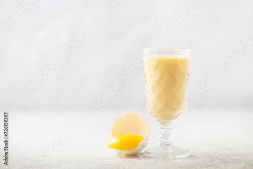 Egg alcohol liquor in a glass. Festive drink.