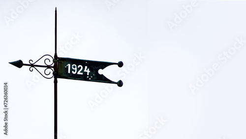 Custom made weathervane in Germany with a year on a banner. In this case 1924. With space for your own text