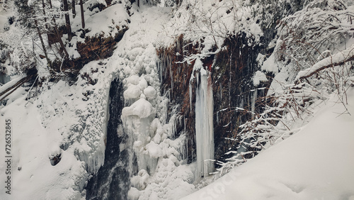 Huk waterfall, frozen waterfall at winter, Carpathian National Park. Ukraine. 