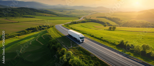 Truck on an open road through vibrant green fields, symbolizing logistics and freedom of travel