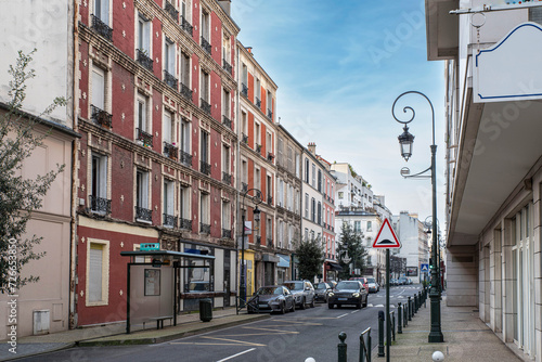 Old red buildings in a street in Paris, France