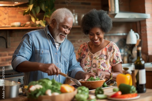 Senior happy smiling african american couple enjoying and cooking healthy dinner together on kitchen at home