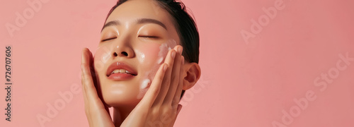 refreshing skincare regime with woman enjoying facial product on rosy background with large copy space 