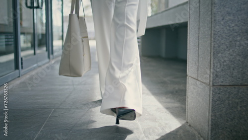 Stylish woman legs walking office in high heels closeup. Girl feet going on work