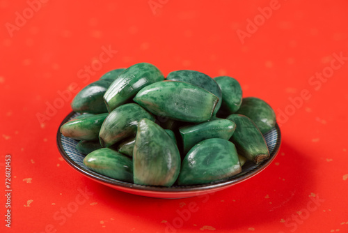 traditional Chinese food Laba garlic pickled garlic on red paper background.