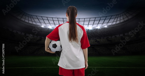 Image of caucasian female soccer player over stadium
