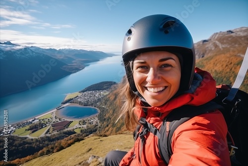 Beautiful woman hiker on the top of a mountain with lake in background