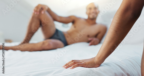 Couple, bed and hand with underwear on duvet for love, romance or intimacy in affection, morning or seduction at home. Closeup of woman, man or lovers lying in bedroom for compassion on anniversary