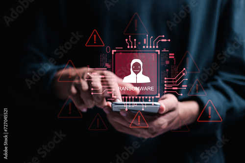 Malware attack virus alert. Ransomware malware attack and data breach. Person use smartphone with virtual warning sign with ransomware word. warning notification, Cyber threats.