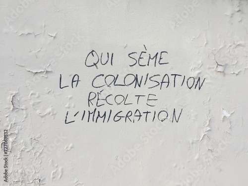 "colonialism is the cause of immigration" graffiti in Paris, France