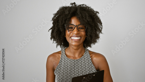 African american woman business worker holding clipboard smiling over isolated white background