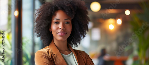 Beauty portrait of african american woman with afro hairstyle. Excited african woman with wide smile looking aside. Confident African American Businesswoman Against office Background.