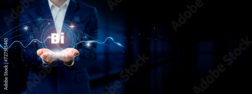 Businessman holding virtual Business Intelligence network connection icons. Data Analytics, Reporting, Insights for Internet business and social network.