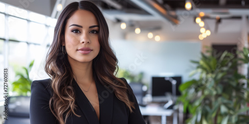 Confident latin businesswoman portrait at her office with copy space