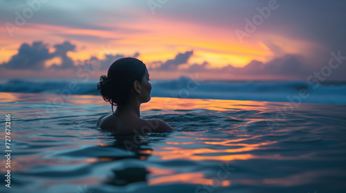 Woman soaking in a hot spring pool on the beach, small waves breaking in the background, colorful night sky creates a romantic atmosphere, Ai Generated Images