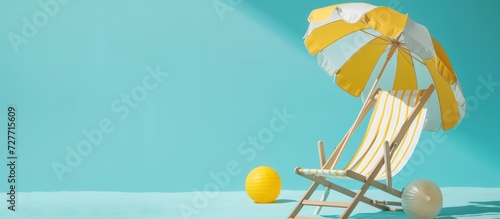 Summer holiday concept beach chair with yellow umbrella and Ball on blue background. Generated AI
