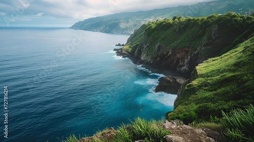 Breathtaking View of Green Coastal Cliffs Meeting Deep Blue Ocean Waves and Lush Vegetation
