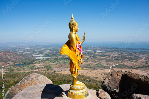 Buddha on cliff of Khao Phraya Doen Thong mountain for thai people travelers travel visit trail trekking go to respect praying blessing wish holy mystery at Phatthana Nikhom city in Lop Buri, Thailand