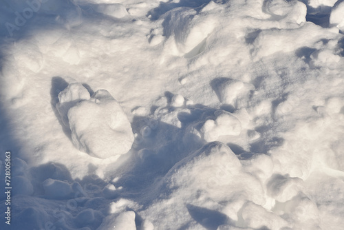 Lumps of snow in winter. Snow and light during the day. Snowdrifts.