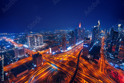 Aerial top view night cityscape of Dubai downtown skyscrapers with illuminated and highway. Business and financial modern district of city UAE
