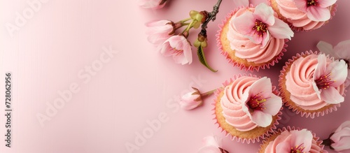 Cupcakes with pink frosting and cherry blossom topping, sakura-inspired dessert for a hanami party
