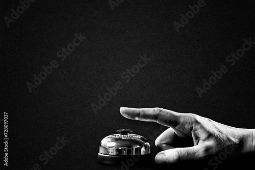 Hand Ringing Service Bell Symbol Gesture Sign in Black and White on Textured Paper Background, Copy Space