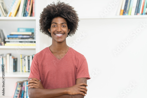 Laughing black male young adult with crossed arms