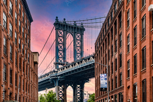 Wonderful sunrise or sunset in Dumbo the trendy Brooklyn neighborhood with picturesque views of the Manhattan skyline and its bridge, famous in New York City (USA).