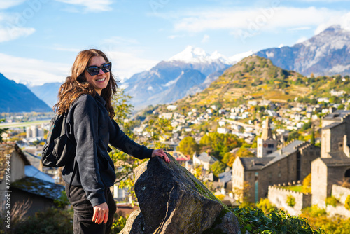 Woman smiling at the camera. Sion town,spectacular set in the swiss Alps mountains valley, canton Valais, Switzerland