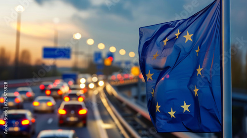 Vielbefahrene Straße mit Flagge der Europäischen Union (EU) im Vordergrund.