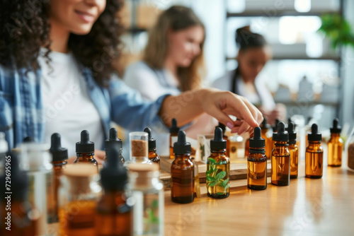 A woman explains products at an essential oils workshop, surrounded by shelves of bottled oils.