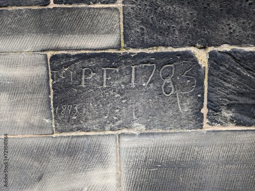 Example of historical graffiti from 1783 scratched into church brickwork