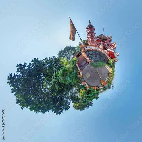 little planet with hindu maruti temple of ape goddess hanuman in jungle in Indian tropic village on tiny planet in blue sky, transformation of spherical 360 panorama.
