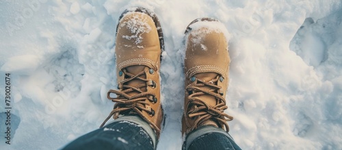 Winter boots for women, viewed from above in a snowdrift.