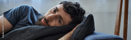 depressed man in casual outfit lying on sofa during breakdown, mental health awareness, banner