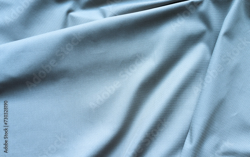 Top view of gray blue textile background with large creases and empty space for text. Stylish suiting fabric with textured pattern made from natural fibers. Flat lay, close-up, copy space, mockup