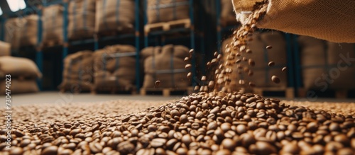 Close up raw coffee beans pouring from handful to the sack in a warehouse. AI generated image