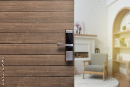 Digital Door handle or Electronics knob for access hotel room security, Door wooden half opening through interior living room background, selective focus