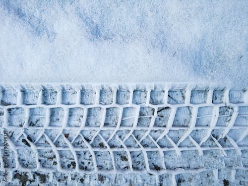 Tire tread prints on the ground. tire tracks. Tire tracks on a sandy road. Car tread prints on the sand. Footprint and traces of an off-road car tires in the mud. tire prints in the snow.