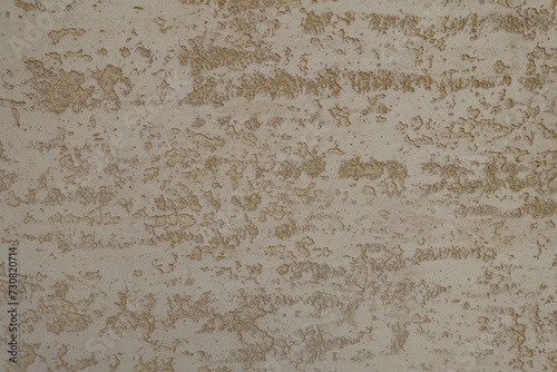Close up of beige semi-smooth wall with stucco lace finish